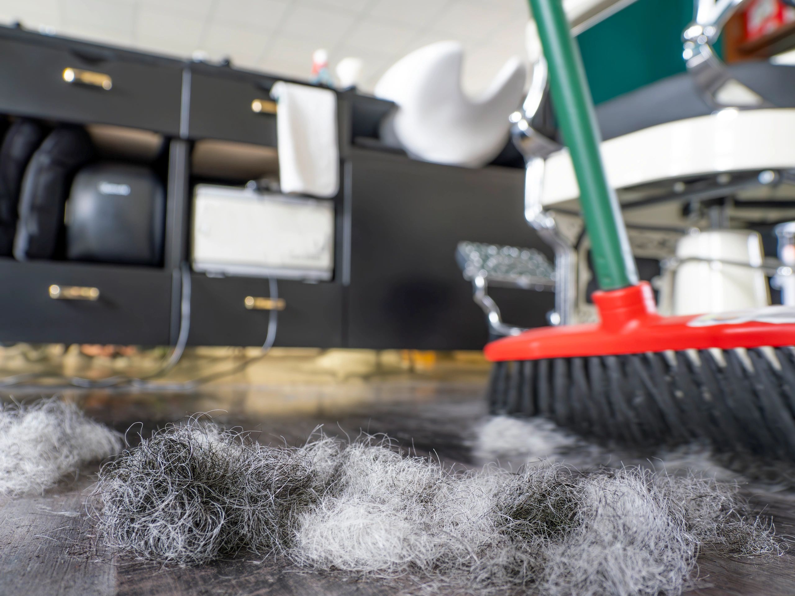 Professional cleaner sweeping and tidying an interior space